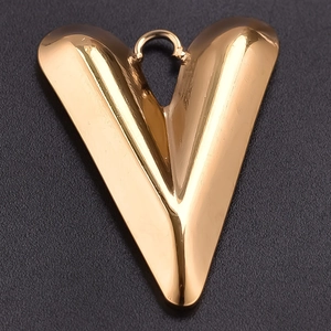 Detailed view of a golden stainless steel V-shaped heart pendant with polished finish