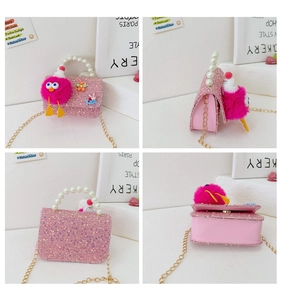 Detail view of pink sequin kids bag with pearl handle and plush rabbit pendant