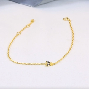 Detailed macro view of S925 silver bee bracelet with colorful gemstones and golden finish