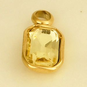 Macro shot of 304 stainless steel gold pendant with rectangular yellow glass stone