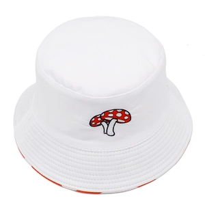 Detail of white cotton bucket hat with a red and white mushroom embroidery on top