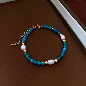 Detailed macro view of natural blue stones and baroque pearls on adjustable necklace