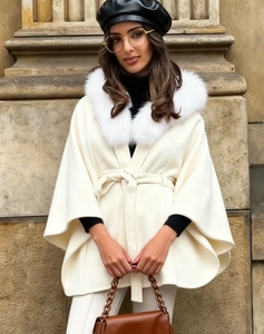Detail of white faux fur collar coat with textured wool blend material in street style