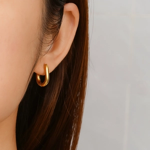 Elegant 18K gold plated stainless steel U-shaped hoop earrings for women on model