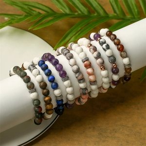 Macro detail of natural amethyst and lava stone beaded bracelets on white display