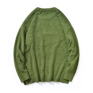 Macro detail of the grass green plush texture and knit fabric on this men's sweater