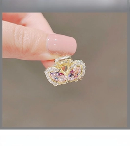 Detail of pink crystal rabbit ear hair clip with sparkling rhinestones in hand