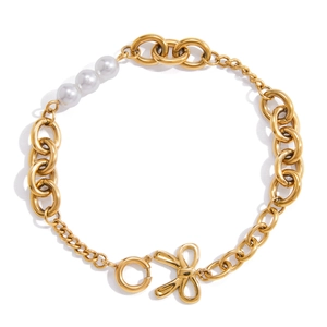 Retro gold bow bracelet with three white pearls on a clean white background