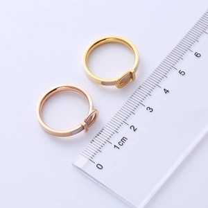 Detailed view of buckle rings in gold and rose gold with rulers showing 2cm diameter