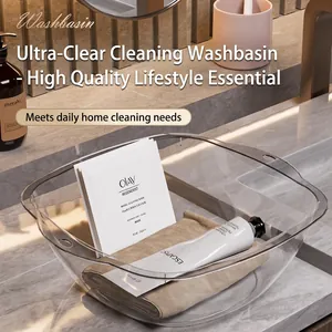 Minimalist transparent washbasin with handles for bathroom use on marble countertop