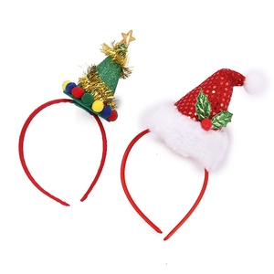 Detail of festive headbands featuring a green Christmas tree and a red sequin Santa hat