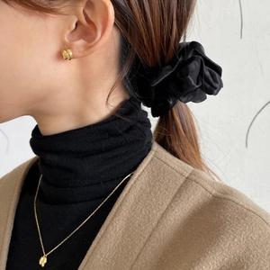 Minimalist gold bar earrings and delicate floral necklace styled with a black scrunchie