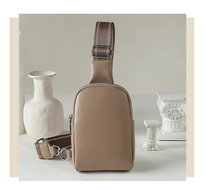 Close-up of minimalist earthy-toned PU leather chest bag with silver hardware detail