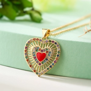 Golden heart pendant necklace with red enamel and colored cubic zirconia on O-chain