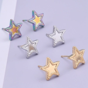 Macro shot of star-shaped 304 stainless steel studs in gold, silver, and rainbow finishes