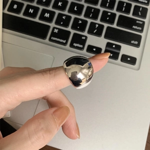 Minimalist wide mirror-polished silver ring for women worn on index finger