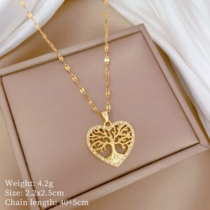 Close-up of golden Tree of Life heart pendant with crystals on silk background