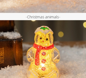 Close-up of glowing gingerbread man figurine with LED lights and red scarf