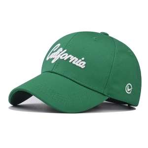 Close-up of white California embroidery and circular logo on dark green cotton cap