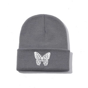 Grey knit beanie featuring white butterfly embroidery for streetwear style