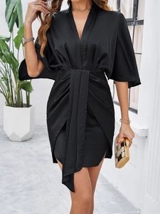 Detail view of the V-neck design and draped ruffle texture on the black elegant mini dress