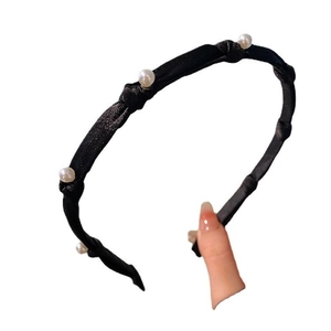 Elegant black bow headband with white pearls and twisted fabric texture on white background