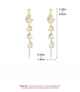 Detailed view of long gold tassel earrings with zircon stones and size specifications