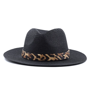 Detail of black straw fedora with leopard print band and golden rivet accent