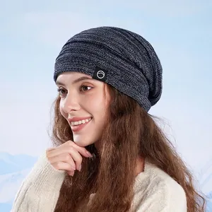 Winter knitted slouchy beanie for women in navy blue blend with warm fleece lining