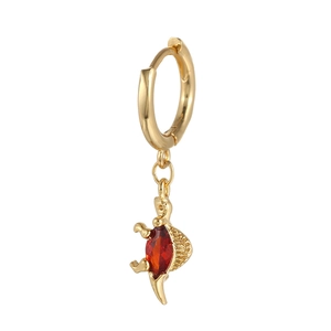 Detail of dinosaur drop earring featuring a large red teardrop zircon in gold finish
