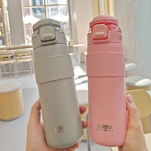 Detail of grey and pink matte sports bottles with anti-slip grip and carrying handles