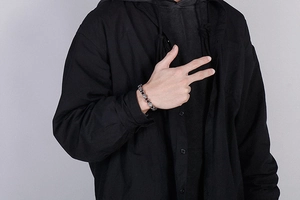 Close-up of vintage geometric punk metal chain bracelet on a male model's wrist