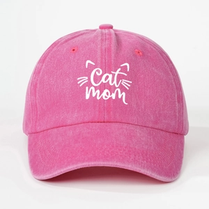 Close-up of pink cotton baseball cap with white Cat Mom embroidery and cat whiskers