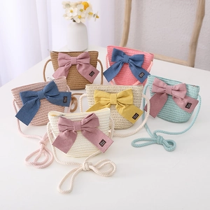 Straw woven crossbody bags for kids with large bow detail in six assorted summer colors