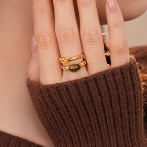 Detailed macro of 18k gold plated double-layer rings with tiger eye and zircon stones