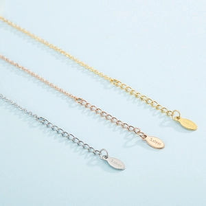 Macro shot of stainless steel extender chains in gold, rose gold, and silver finishes