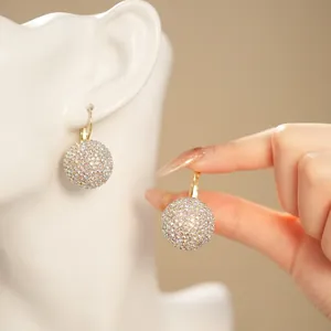 Golden hook earrings with disco ball pendant encrusted in colorful sparkling crystals