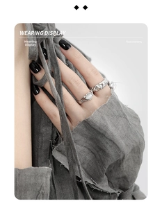 Detailed view of silver rings set with a moonstone and textured lava-style finish