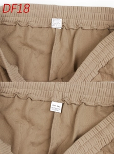 Close-up of garment labels showing 95% polyester and 5% elastane composition and XXL size