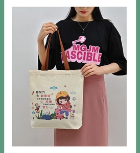 Detail of canvas tote bag featuring cartoon girl illustration and inspirational text