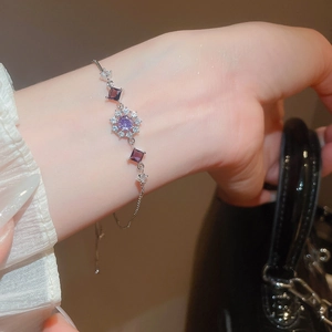 Detail of adjustable silver bracelet with purple snowflake crystals and zircon accents