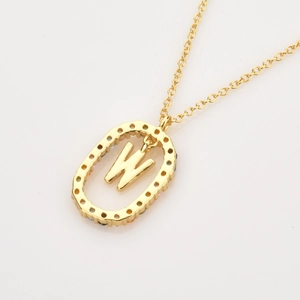 Detailed macro view of the gold 925 silver necklace with letter W pendant and colorful zircons