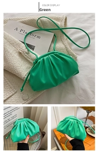 Detail of green ruched cloud bag showing soft PU leather texture and magnetic closure