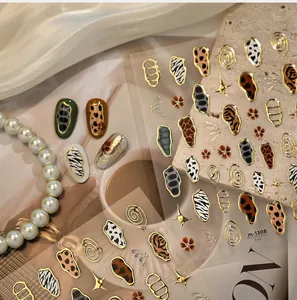 Chic animal print nail stickers with metallic gold edges featuring leopard and zebra patterns