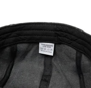 Detailed close-up of the cotton flat cap inner lining with care label and size information