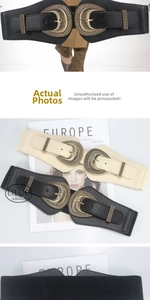 Detail of wide elastic waist belt with large metal buckle in black and apricot