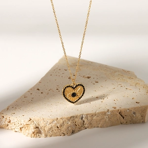 18K gold stainless steel heart necklace with black stones and evil eye pendant on stone