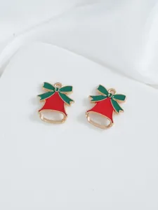 Detail of red Christmas bell charms with green bows for DIY jewelry making