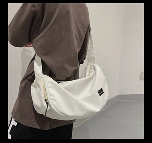 Detail showing white crescent nylon fitness bag with wide adjustable shoulder strap