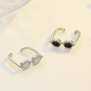 Detail of creative sunglasses-shaped rings with micro-inlaid diamonds in black and white